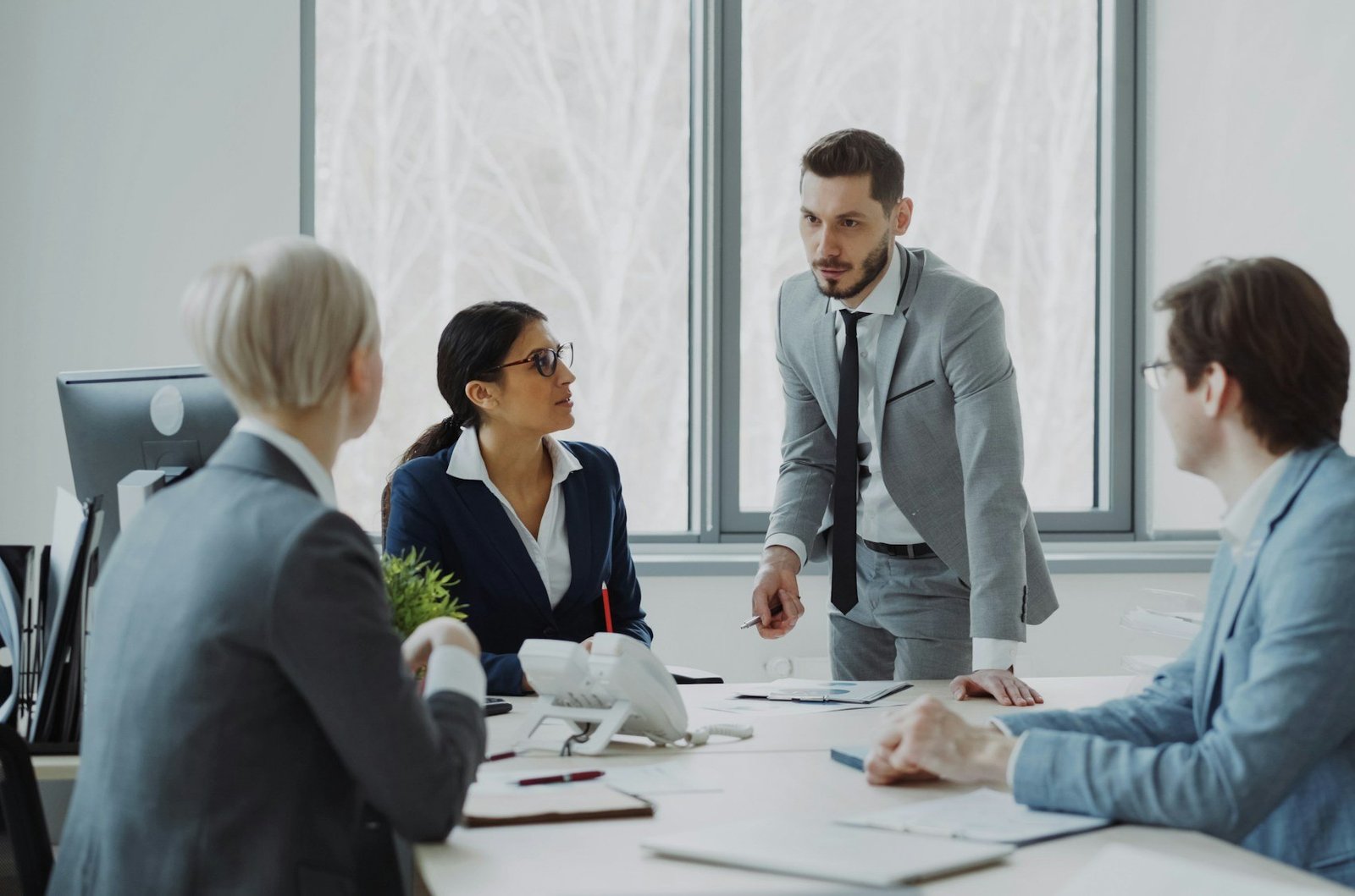 Bridgeforce consultants working through a problem together around a conference table